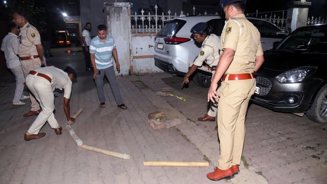 Police personnel investigate a crime scene after Businessman Gopal Khemka was shot dead near his residence in Patna on Saturday. 