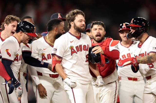 The Angels’ Nolan Schanuel (18) celebrates with teammates after he drew a bases-loaded walk to drive in the winning run in the bottom of the ninth inning of their 6-5 victory over the Texas Rangers on Monday night at Angel Stadium. (Photo by Ronald Martinez/Getty Images)