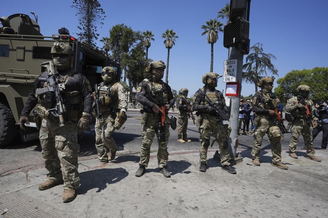 Federal agents at MacArthur Park Monday, July 7, 2025, in Los Angeles.