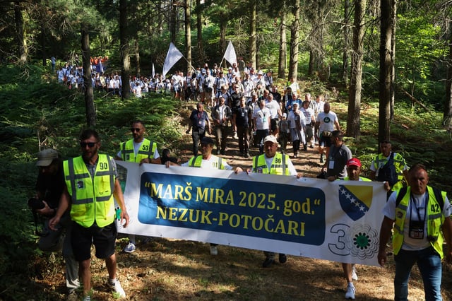 People participate in the "March of Peace" in memory of the 1995 Srebrenica massacre, in Nezuk, Bosnia, Tuesday, July 8, 2025. (AP Photo/Armin Durgut)