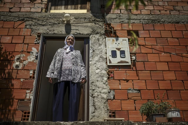 Sefika Mustafic, 72, stands in front of her home in the village of Potocari near Srebrenica, Bosnia, on June 29, 2025. During the genocide a total of 15 members of her family were killed. (AP Photo/Armin Durgut)