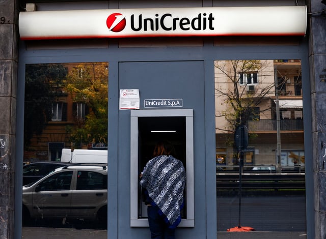 A person uses an ATM at a UniCredit bank branch in Rome, Italy, November 25, 2024. REUTERS/Yara Nardi/File Photo