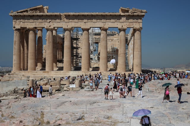 People visit the Acropolis, at the start of a 3-days heatwave with temperatures expected to overpass 40 Celsius degrees, in Athens, Greece, July 7,  2025. REUTERS/Louisa Gouliamaki