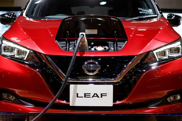 A charging cable is attached to a Nissan Leaf electric car at the Tokyo Motor Show, in Tokyo, Japan, October 24, 2019. REUTERS/Edgar Su/File Photo