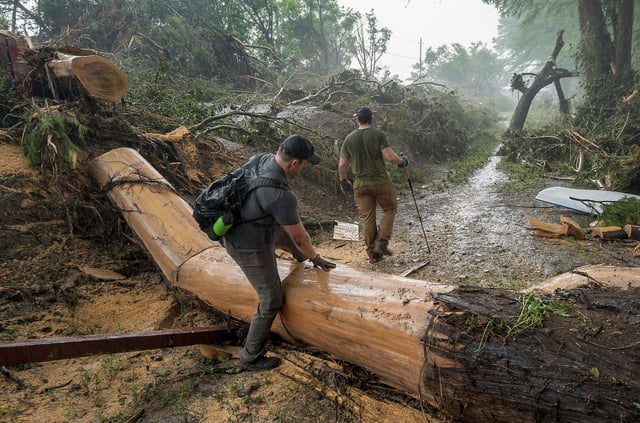 Volunteers search for missing people along the banks of the Guadalupe River after recent flooding on Sunday, July 6, 2025, in Hunt, Texas. (AP Photo/Rodolfo Gonzalez)