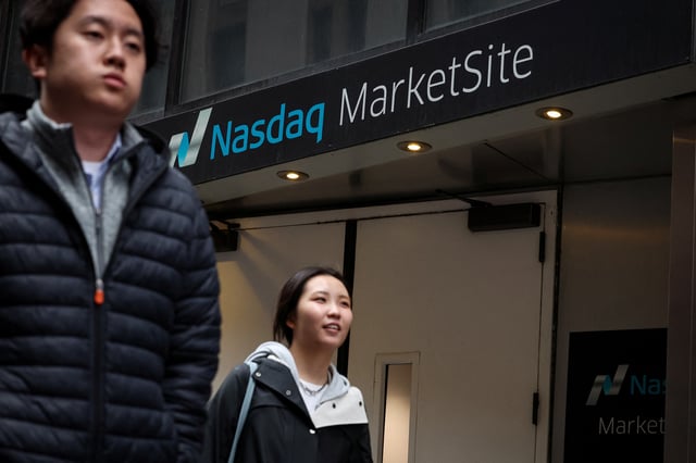 People walk outside the Nasdaq Marketsite in New York City, U.S., April 3, 2025.  REUTERS/Brendan McDermid/File Photo