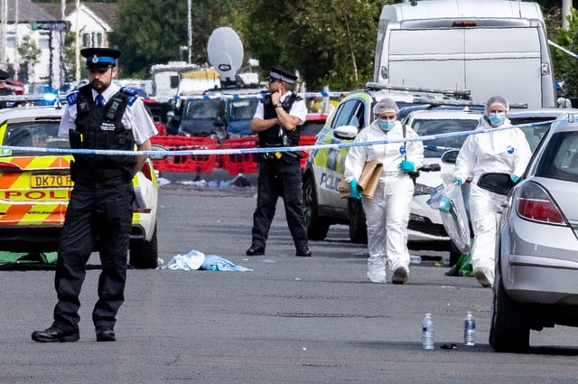 Police at the scene following the fatal stabbings in Merseyside in July