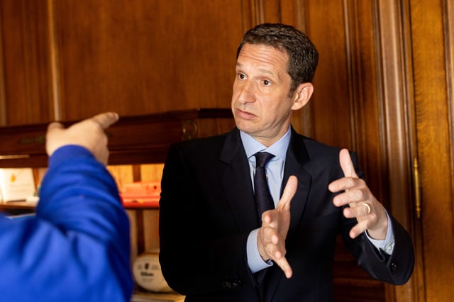 Mayor Daniel Lurie speaks to a reporter in his office at City Hall in San Francisco on April 8, 2025. Lurie has recently reached the milestone of 100 days in office.