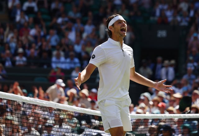 Tennis - Wimbledon - All England Lawn Tennis and Croquet Club, London, Britain - July 8, 2025 Taylor Fritz of the U.S. celebrates winning his quarter final match against Russia's Karen Khachanov REUTERS/Isabel Infantes