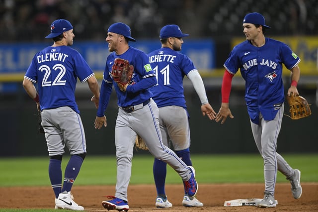 Toronto Blue Jays' Ernie Clement (22) celebrates with Myles Straw, second from left, as Bo Bichette (11) celebrates with Joey Loperfido, right, after they defeated the Chicago White Sox in a baseball game Monday, July 7, 2025, in Chicago.
