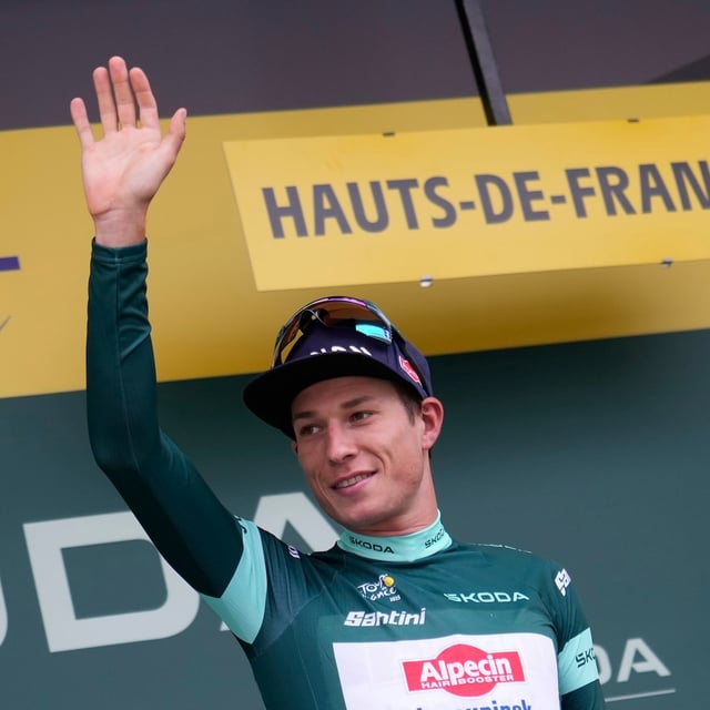 Belgium's Jasper Philipsen wearing the best sprinter's green jersey celebrates on the podium after the second stage of the Tour de France cycling race over 209.1 kilometers (129.9 miles) with start in Lauwin-Planque and finish in Boulogne-sur-Mer, France, Sunday, July 6, 2025. (AP Photo/Mosa'ab Elshamy)