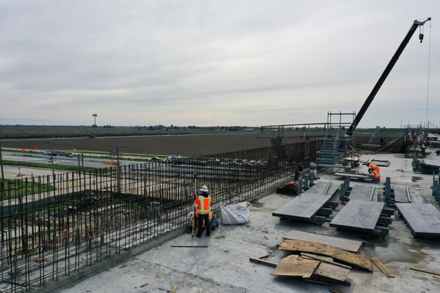 An aerial image shows construction workers building the Hanford Viaduct over Highway 198 as part of the California High Speed Rail (CAHSR) transit project in Hanford, California on February 12, 2025.