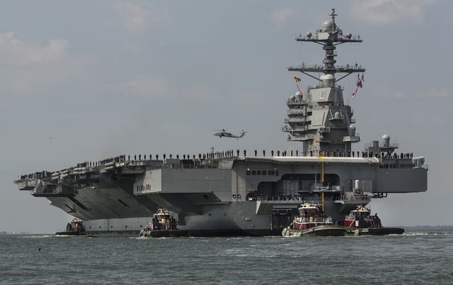 As crew members stand on the deck, the aircraft carrier USS Gerald R. Ford heads to the Norfolk, Va., naval station on Friday, April 14, 2017 after almost a week of builder&#39;s trials during which the ships systems were tested.