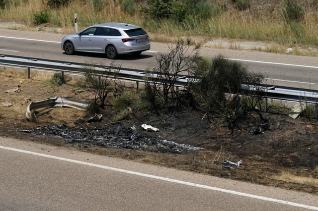 Debris and burn marks are seen along the A-52 motorway at the crash site where Diogo Jota and his brother Andre Silva died