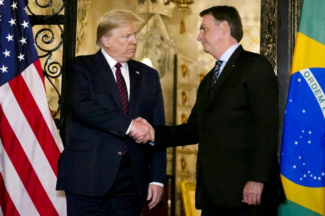 President Donald Trump shakes hands with Brazil's President Jair Bolsonaro at Trump's Mar-a-Lago resort on March 7, 2020.