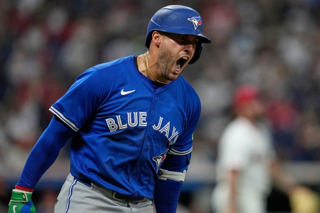 Toronto Blue Jays&#39; George Springer shouts as he runs the bases with a home run in the eighth inning of a baseball game against the Cleveland Guardians in Cleveland, Tuesday, June 24, 2025. (AP Photo/Sue Ogrocki)