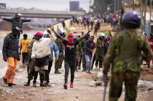 ADDITION: CLARIFIES DATE - Demonstrators gesture to anti-riot police during demonstrations to mark the historic 1990 Saba Saba (a Swahili word that means seven seven) protests for democratic reforms in the Kangemi slum of Nairobi, Kenya, Monday, July 7, 2025. (AP Photo/Brian Inganga)