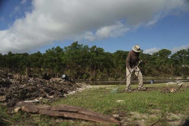 Charles Hanson, 91, cleans up flood debris, Tuesday, July 8, 2025, at Guadelupe Park in Kerrville, Texas. (AP Photo/Joshua A. Bickel)