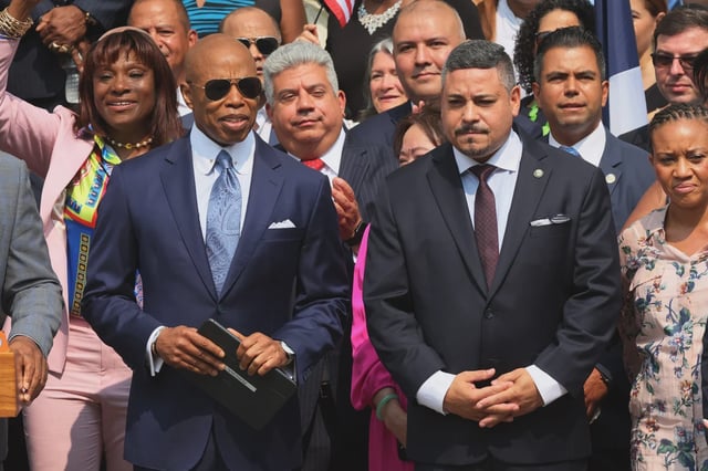 New York Mayor Eric Adams and First Deputy Commissioner Edward A. Caban stand silently as they arrive for a press conference at the NYPD 40th Precinct on July 17, 2023 in New York City.