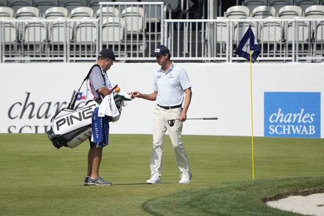 May 26, 2023; Fort Worth, Texas, USA; Harris English and his caddie Eric Larson on the eight green after he hit a hole in one during the second round of the Charles Schwab Challenge golf tournament. Mandatory Credit: Jim Cowsert-USA TODAY Sports/File Photo