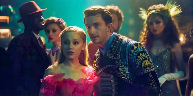 Glinda (Ariana Grande) and Fiyero (Jonathan Bailey) talk about Elphaba (Cynthia Erivo) at the Ozdust Ballroom in 'Wicked'.