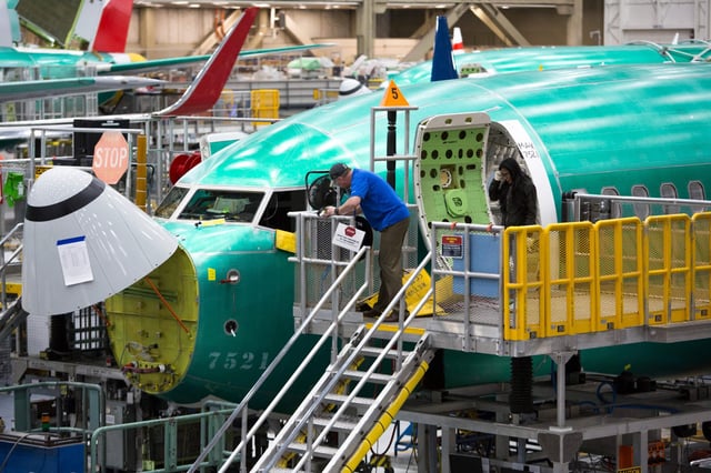 Employees work on Boeing 737 MAX airplanes at the Boeing Renton Factory are in Renton, Washington on March 27, 2019.