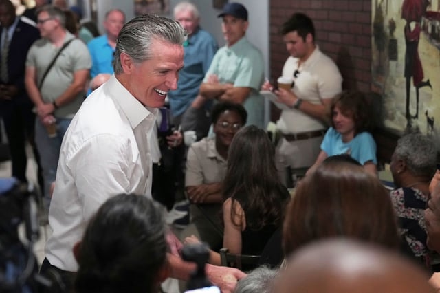 Gov. Gavin Newsom, D-Calif., greets people in a coffee shop during a two-day swing through South Carolina on Tuesday, July 8, 2025, in Florence, S.C. (AP Photo/Meg Kinnard)