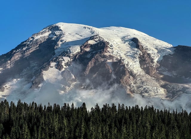 Mount Rainier, an active volcano rising to 14,410 feet, is experiencing a rare earthquake swarm.
