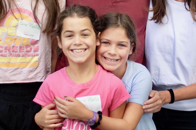 Rebecca Lawrence, right, hugs her eight-year-old twin sister Hanna Lawrence as they pose for a photo on June 29, 2025, the day they were dropped off at Camp Mystic. The twins died in a July 4, 2025 flood that overwhelmed the Hunt, Texas camp and surrounding area.