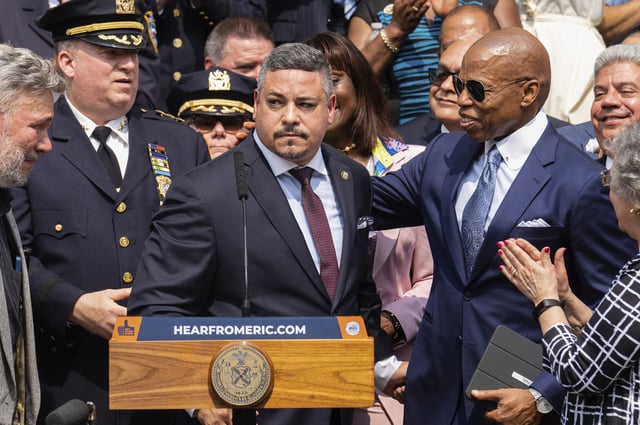 FILE - Edward A. Caban, center, speaks after being sworn in as NYPD police commissioner outside New York City Police Department 40th Precinct on July 17, 2023, in New York. Mayor Eric Adams on the right. (AP Photo/Jeenah Moon, File)