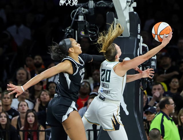 Sabrina Ionescu #20 of the New York Liberty is fouled as she shoots a layup against A&#39;ja Wilson #22 of the Las Vegas Aces in the third quarter of their game at Michelob ULTRA Arena on June 15, 2024 in Las Vegas, Nevada. The Liberty defeated the Aces 90-82.