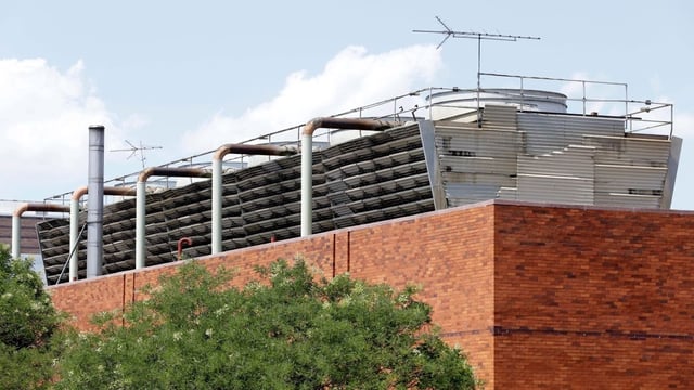 An air-conditioning unit sits atop a building at Lincoln Hospital in the Bronx borough of New York City in 2015. Heavy-duty rooftop air-conditioning equipment was suspected of releasing bacteria-laden mist and causing a deadly outbreak of legionnaires' disease.