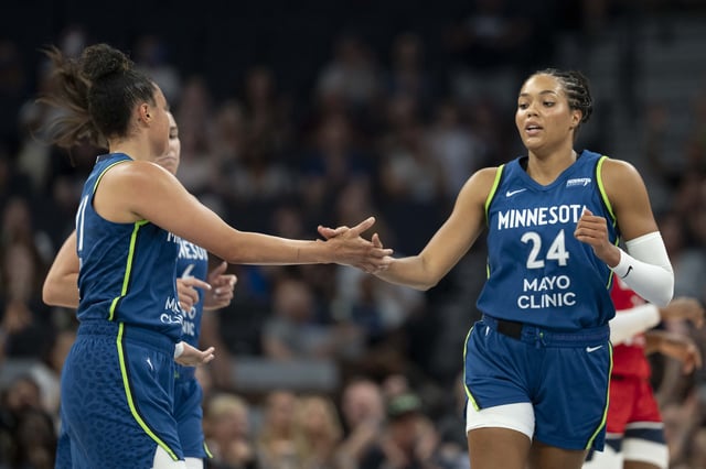 Jul 3, 2025; Minneapolis, Minnesota, USA; Minnesota Lynx forward Napheesa Collier (24) shakes hands with Minnesota Lynx guard Kayla McBride (21) after making a shot against the Washington Mystics in the first half at Target Center. Mandatory Credit: Jesse Johnson-Imagn Images/File Photo