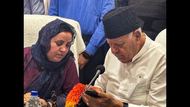 Jammu and Kashmir National Conference president Farooq Abdullah with state education minister Sakina Itoo during workers convention in Kulgam on Tuesday. (PTI)