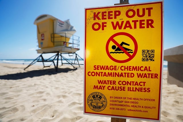 A sign warns people of the contaminated ocean water in Imperial Beach, which has been plagued by untreated sewage from Tijuana for years. (U-T)