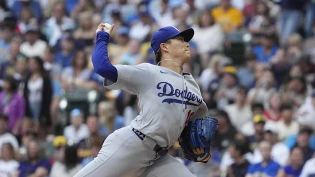 Jul 7, 2025; Milwaukee, Wisconsin, USA; Los Angeles Dodgers pitcher Yoshinobu Yamamoto (18) delivers a pitch against the Milwaukee Brewers in the first inning at American Family Field. Mandatory Credit: Michael McLoone-Imagn Image