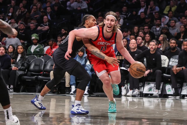 Apr 8, 2025; Brooklyn, New York, USA;  New Orleans Pelicans forward Kelly Olynyk (13) looks to drive past Brooklyn Nets guard Tyson Etienne (10) in the third quarter at Barclays Center. Mandatory Credit: Wendell Cruz-Imagn Images/File Photo