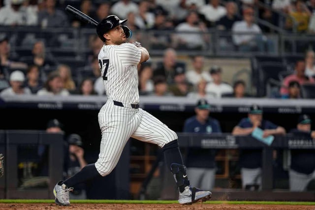 New York Yankees designated hitter Giancarlo Stanton (27) hits a two-run home run during the sixth inning of a baseball game against the Seattle Mariners, Tuesday, July 8, 2025, in New York. (AP Photo/Yuki Iwamura)