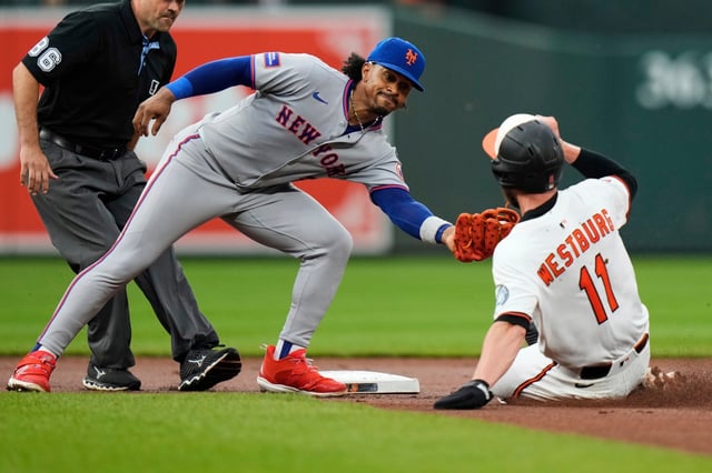 Baltimore Orioles&#39; Jordan Westburg (11) is caught stealing second base by New York Mets shortstop Francisco Lindor (12) during the first inning of a baseball game, Tuesday, July 8, 2025, in Baltimore. (AP Photo/Stephanie Scarbrough)