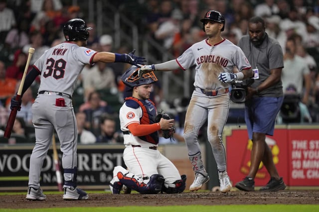 Cleveland Guardians&#39; Brayan Rocchio, right, celebrates with Steven Kwan (38) after hitting a home run as Houston Astros catcher Yainer Diaz kneels behind home plate during the fourth inning of a baseball game Tuesday, July 8, 2025, in Houston. (AP Photo/David J. Phillip)