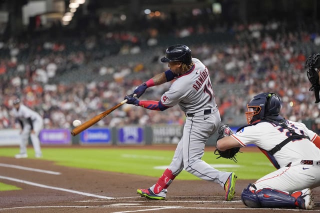 Cleveland Guardians&#39; José Ramírez (11) hits a two-run home run as Houston Astros catcher Yainer Diaz (21) reaches for the pitch during the first inning of a baseball game Tuesday, July 8, 2025, in Houston. (AP Photo/David J. Phillip)