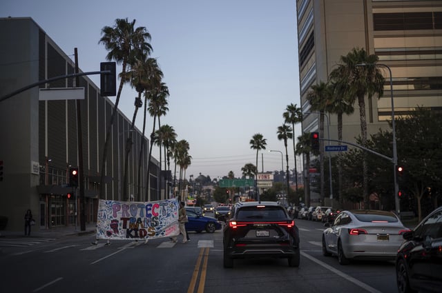 Protesters carry a large banner while demonstrating against the closure of the trans youth clinic at Children's Hospital Los Angeles, Thursday, July 3, 2025, in Los Angeles. (AP Photo/Jae C. Hong)