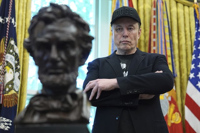 FILE - Elon Musk listens as President Donald Trump speaks during a news conference in the Oval Office of the White House, May 30, 2025, in Washington. (AP Photo/Evan Vucci, File)