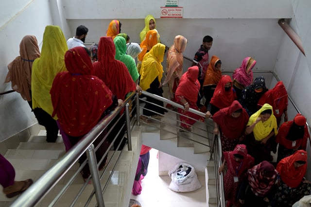 Workers leave a garment factory during their lunch break, in Ashulia, on the outskirts of Dhaka, Bangladesh, April 19, 2025. REUTERS/Fatima Tuj Johora