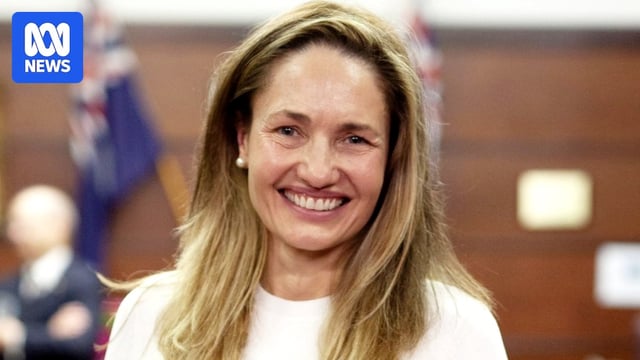 A close up of a woman named Fiona Argyle smiling while wearing a white top. 