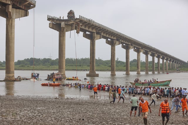 Rescuers and locals look for survivors after several vehicles fell into a river following the collapse of a portion of a bridge in Mujpur near Vadodara in the Indian state of Gujarat, Wednesday, July 9, 2025. (AP Photo)