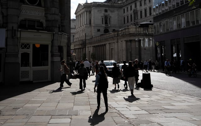 People walk near the Bank of England building in London, Britain, June 24, 2025. REUTERS/Carlos Jasso/File Photo
