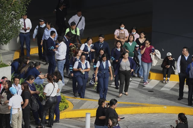 People gather outside of a shopping mall after an earthquake in Guatemala City, Tuesday, July 8, 2025. (AP Photo/Moises Castillo)