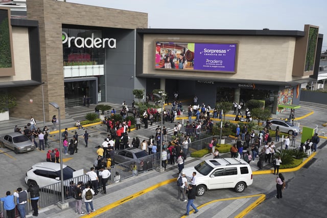 People gather outside of a shopping mall after an earthquake in Guatemala City, Tuesday, July 8, 2025. (AP Photo/Moises Castillo)