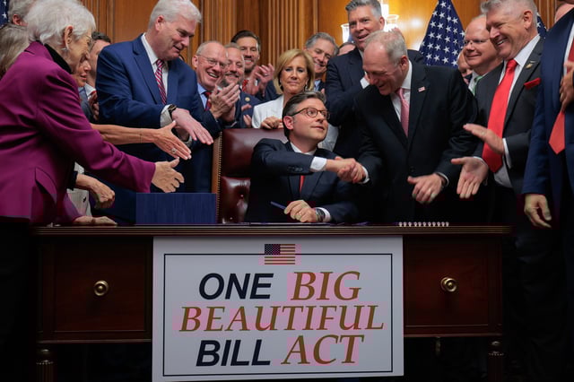 House Speaker Mike Johnson is congratulated by fellow congressional Republicans after signing the One Big Beautiful Bill Act at the U.S. Capitol on July 3, 2025.